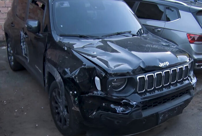 A black Jeep with significant damage to its front and side, indicating a fatal revenge plot incident.