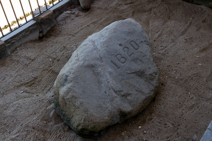 A large grey rock with the number 1620 carved into it, representing historical myths.