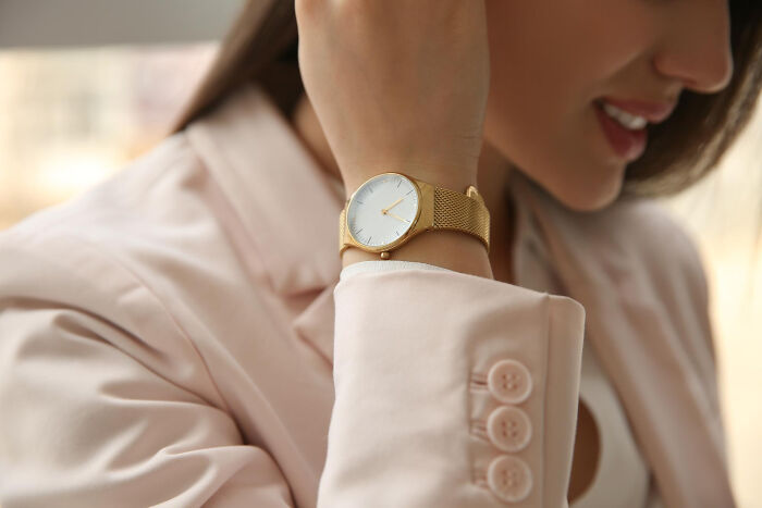 Woman wearing a stylish watch, one of the trends and items that swapped audiences.