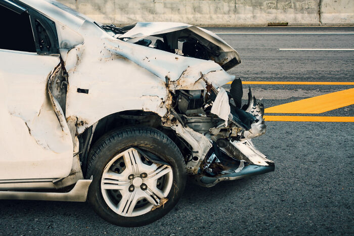 A white car with significant front-end damage, an example of people's intuition.