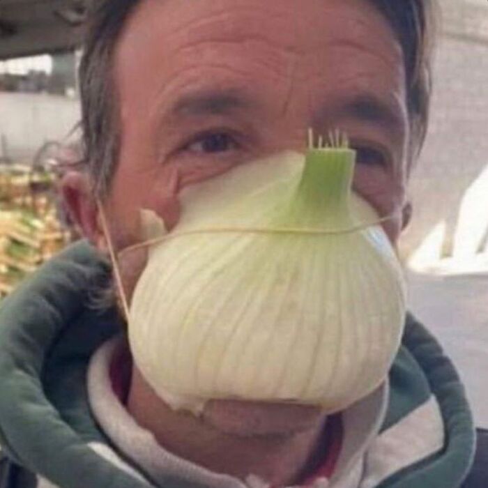 A man with a creepy and confusing onion mask, showcasing strange images.