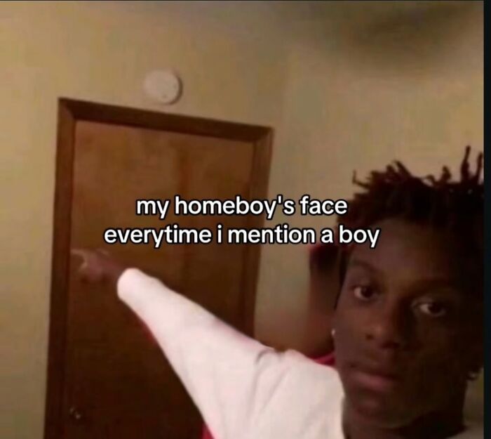 A funny meme of a person pointing, illustrating a friend's reaction every time a boy is mentioned.