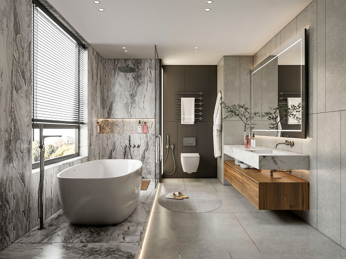 A modern, luxurious bathroom with a freestanding tub, marble walls, and sleek vanity, highlighting guest house etiquette.
