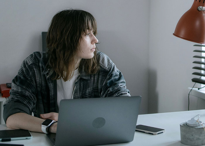 A young woman working on her laptop, illustrating an easy job and a medium salary. A young woman working on her laptop, illustrating an easy job and a medium salary.