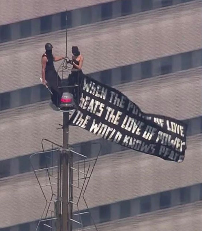 Daredevils hanging a banner on the Empire State Building, moments before their arrest was revealed by NYPD footage.