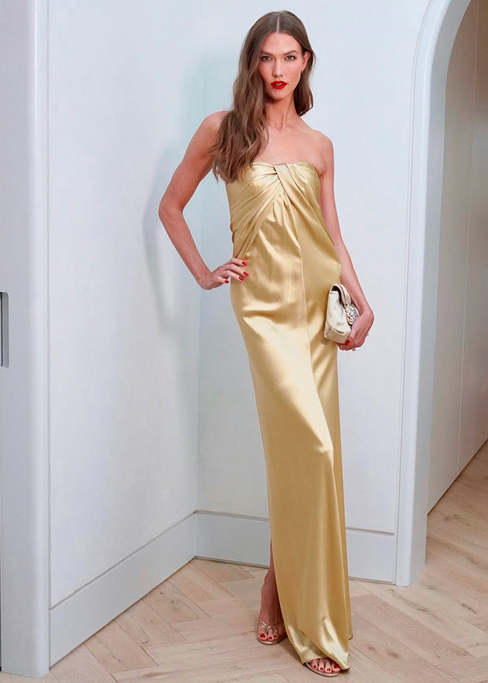 A celebrity in a elegant gold gown, epitomizing the best-dressed celebrities at Taylor Swift’s wedding.