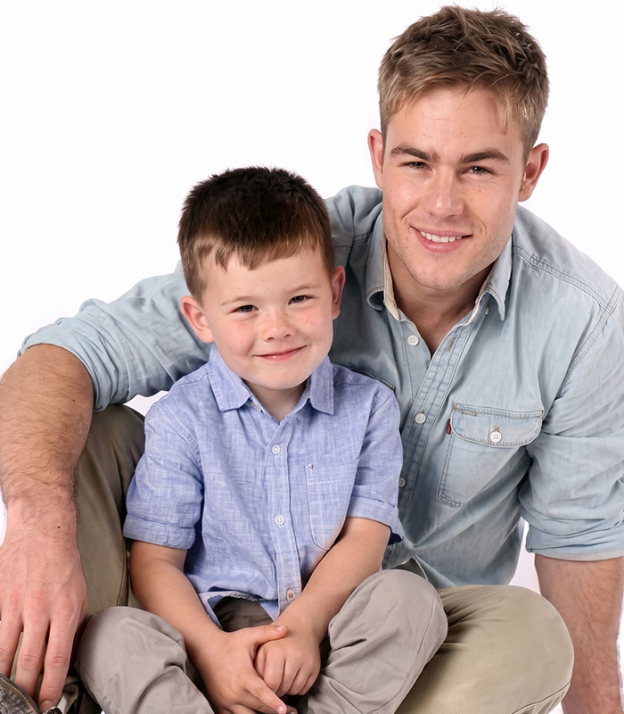 Controversial father-son adult content creators, dad smiling with his young son. Controversial father-son adult content creators, dad smiling with his young son.