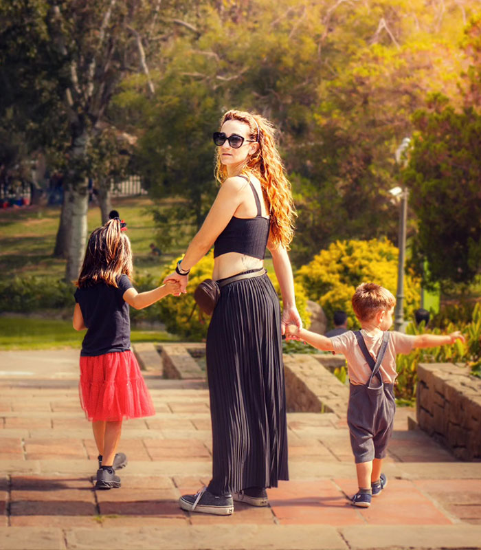 Woman walks with two children, emphasizing the half-siblings' family and the ongoing controversy over their right to marry. Woman walks with two children, emphasizing the half-siblings' family and the ongoing controversy over their right to marry.
