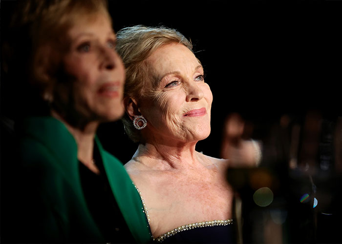 Julie Andrews looking up while seated, a glowing portrait by Disney sparking backlash. Julie Andrews looking up while seated, a glowing portrait by Disney sparking backlash.