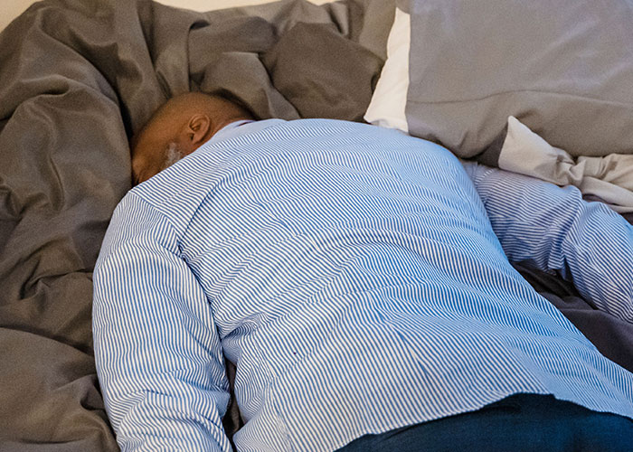 Man sleeping face down, representing men's homes that caused women to leave immediately.