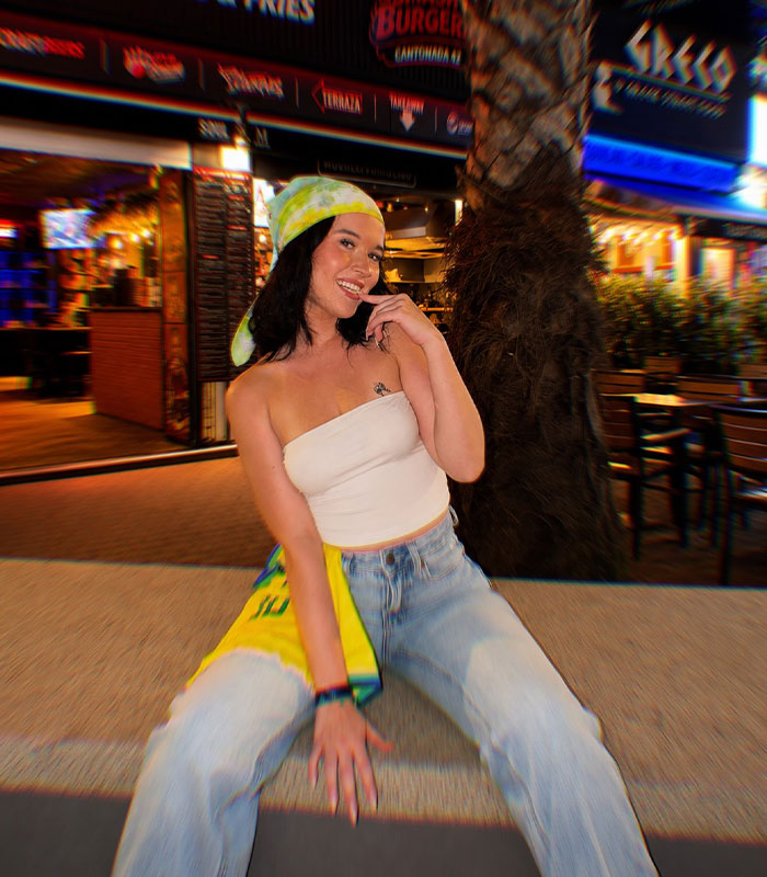 The red bikini woman posing outdoors at night, wearing a bandana, white tube top, and jeans. The red bikini woman posing outdoors at night, wearing a bandana, white tube top, and jeans.
