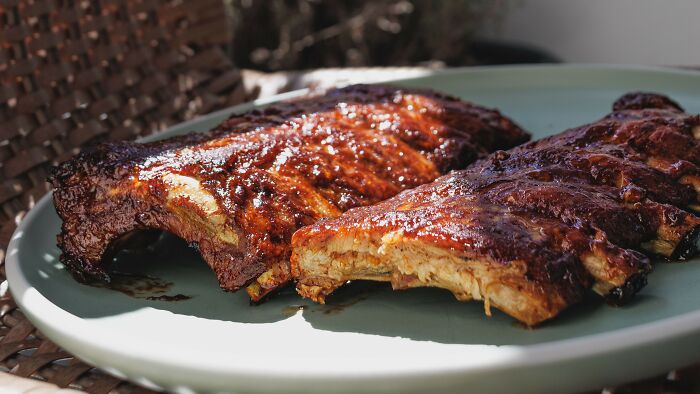 A plate of saucy barbecued ribs, one partially eaten, representing stories where people might have overreacted.