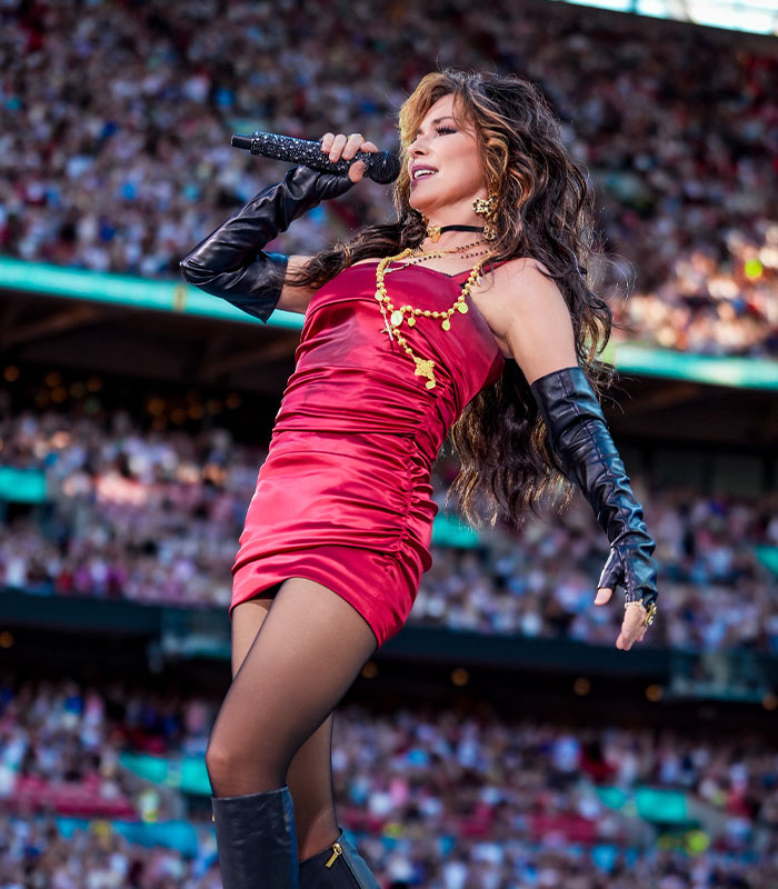 Shania Twain fires back at body shamers in a vibrant red dress and sheer black gloves. Shania Twain fires back at body shamers in a vibrant red dress and sheer black gloves.