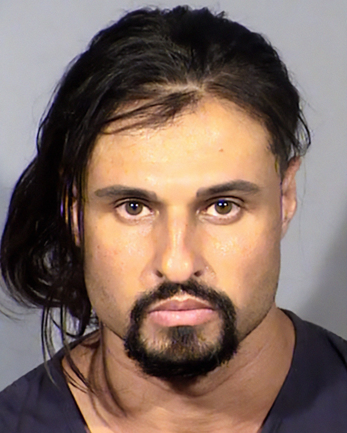Mugshot of a reality star with long hair and a goatee, featured in a list of reality stars who committed serious crimes.