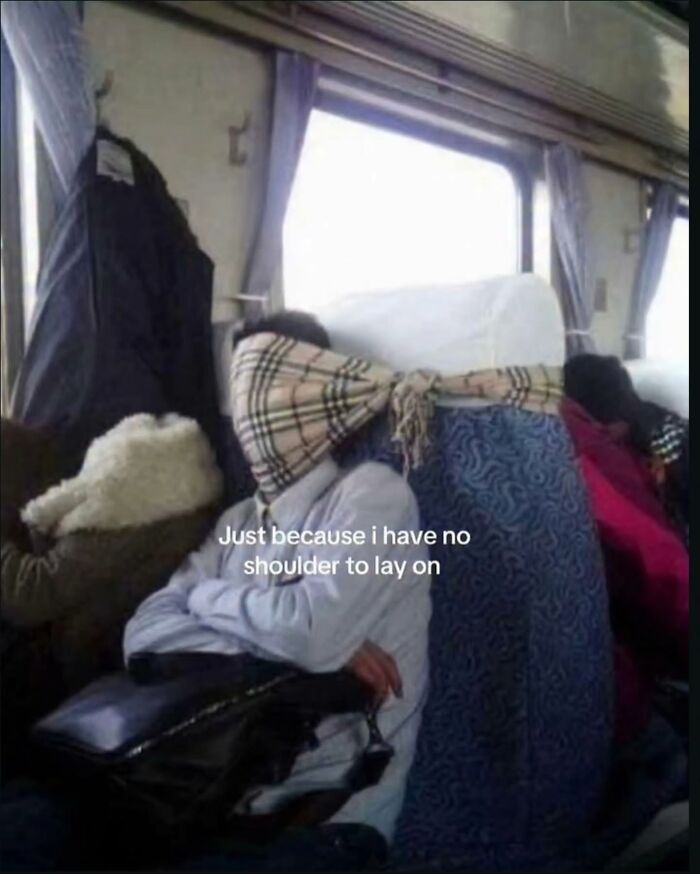 A person sleeping on a bus with a scarf over their head, captioned: Just because I have no shoulder to lay on. Hilarious meme.
