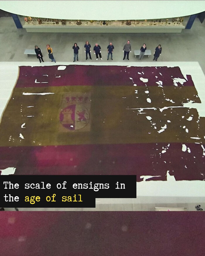 A historical photo showing a large, aged Spanish flag on display, illustrating incredible stories.