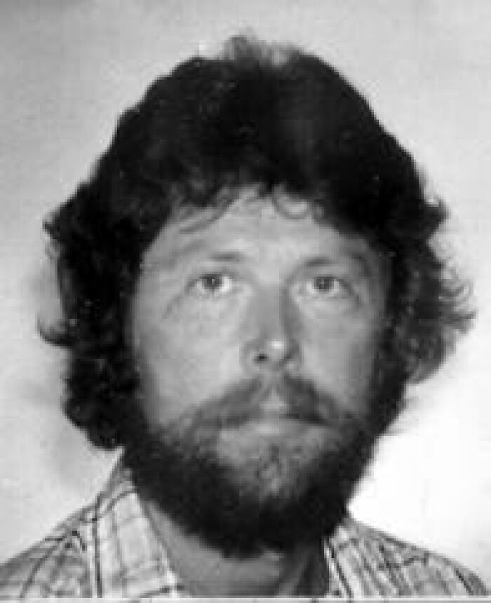 Black and white portrait of a man with a beard, connected to a mystery case where people know who is to blame.