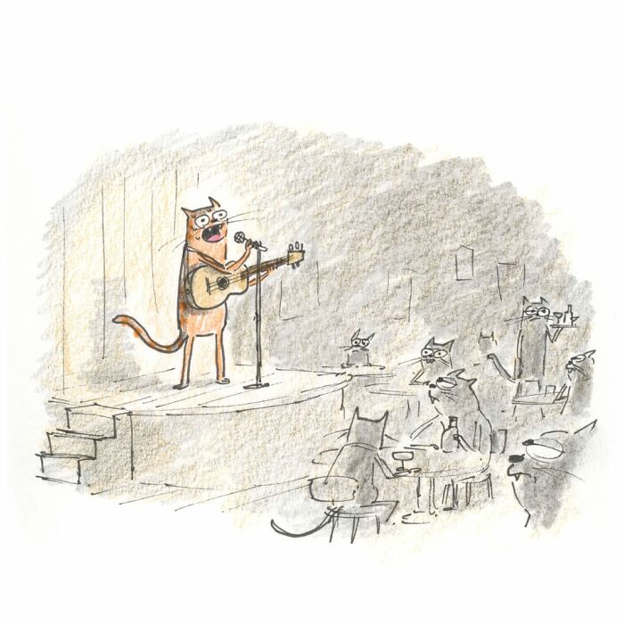 Weird cat comics: A cat performs on stage, playing a guitar and singing to an audience of other cats.