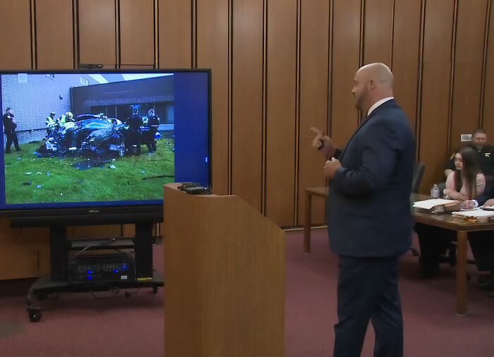 Mackenzie Shirilla appears in court as a lawyer presents evidence of a crashed car on a large screen during a legal setback. Mackenzie Shirilla appears in court as a lawyer presents evidence of a crashed car on a large screen during a legal setback.