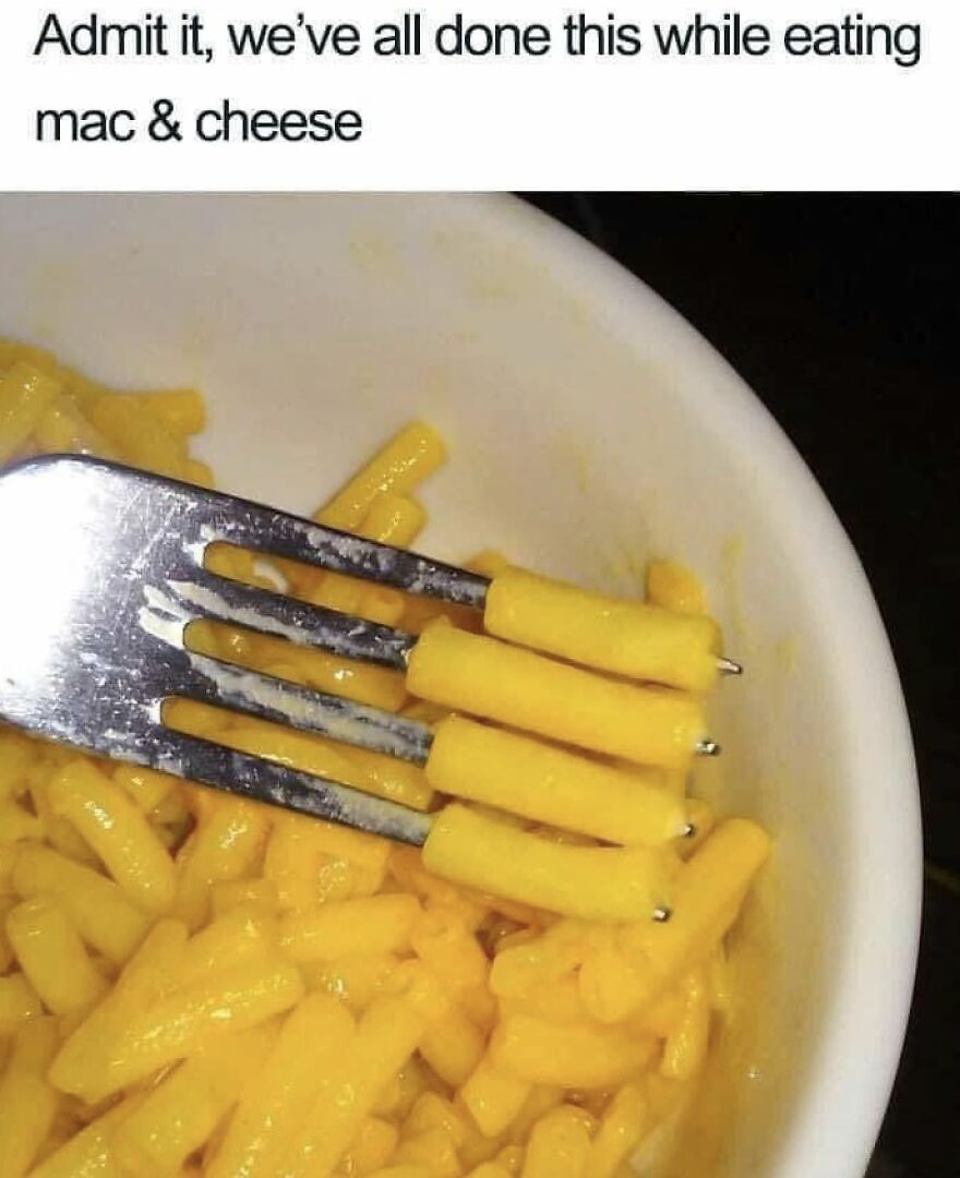 A close-up of a fork with mac & cheese noodles perfectly aligned, a relatable memory for 90s babies.