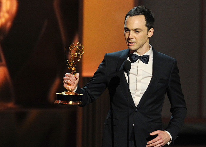 Jim Parsons, The Big Bang Theory star, holding an Emmy award on stage, representing the personal price he paid for fame. Jim Parsons, The Big Bang Theory star, holding an Emmy award on stage, representing the personal price he paid for fame.