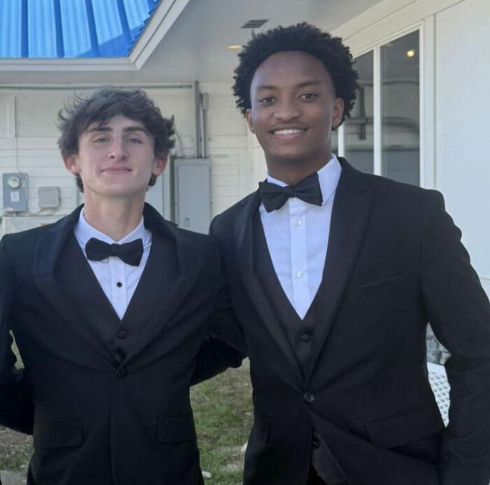 Nolan Wells' best friend and another young man smiling in black tuxedos, at a formal event. Nolan Wells' best friend and another young man smiling in black tuxedos, at a formal event.