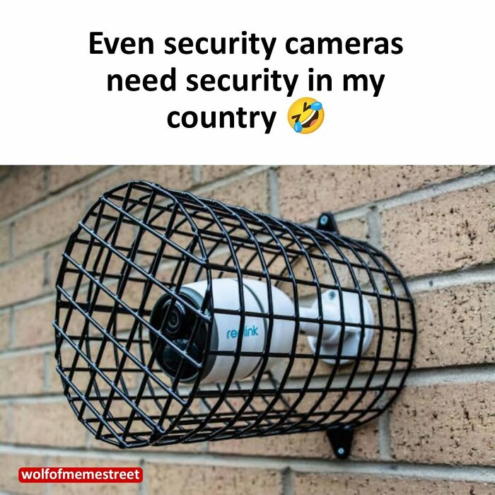 Hilarious post from Xavier: A security camera encased in a metal cage on a brick wall.