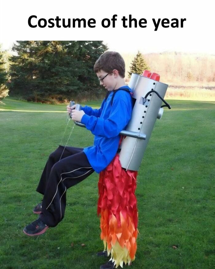 A boy wearing a rocket costume with flames, labeled as costume of the year, from Xavier's hilarious posts.