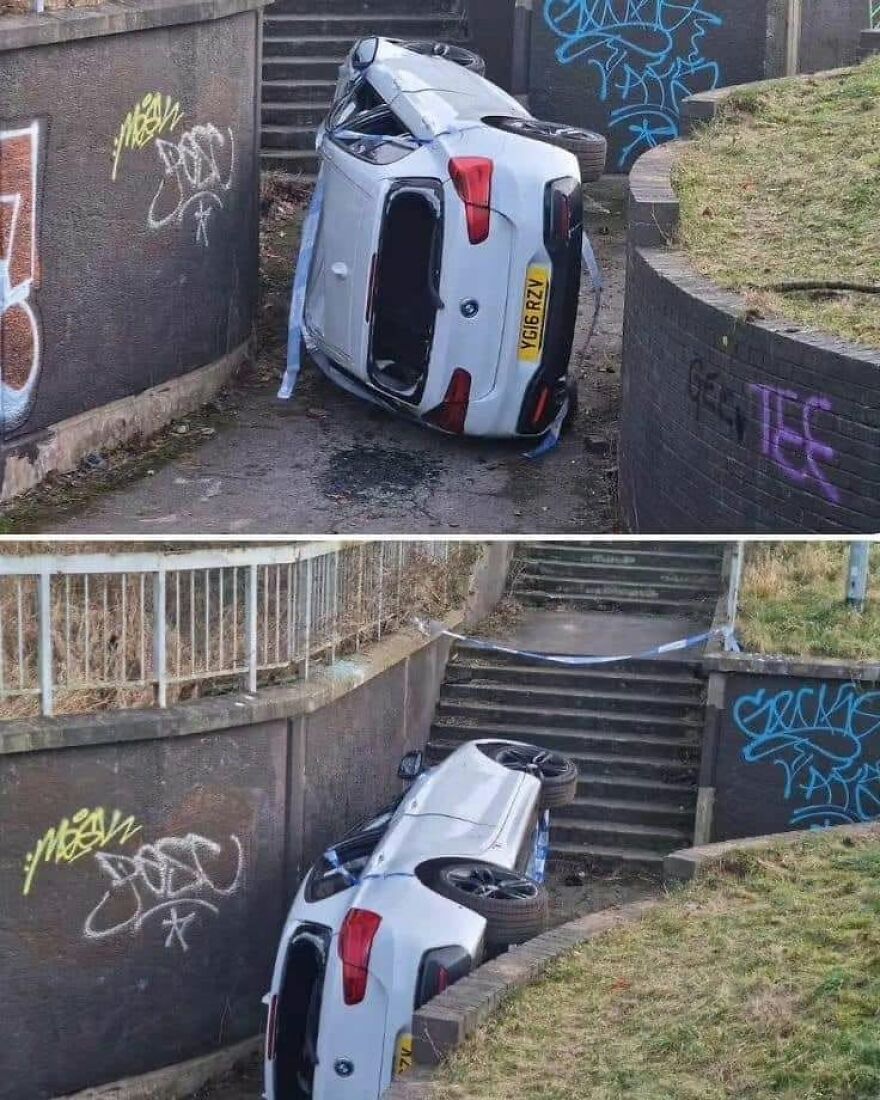 A white car had a rough day behind the wheel, flipped upside down on a concrete stairway.