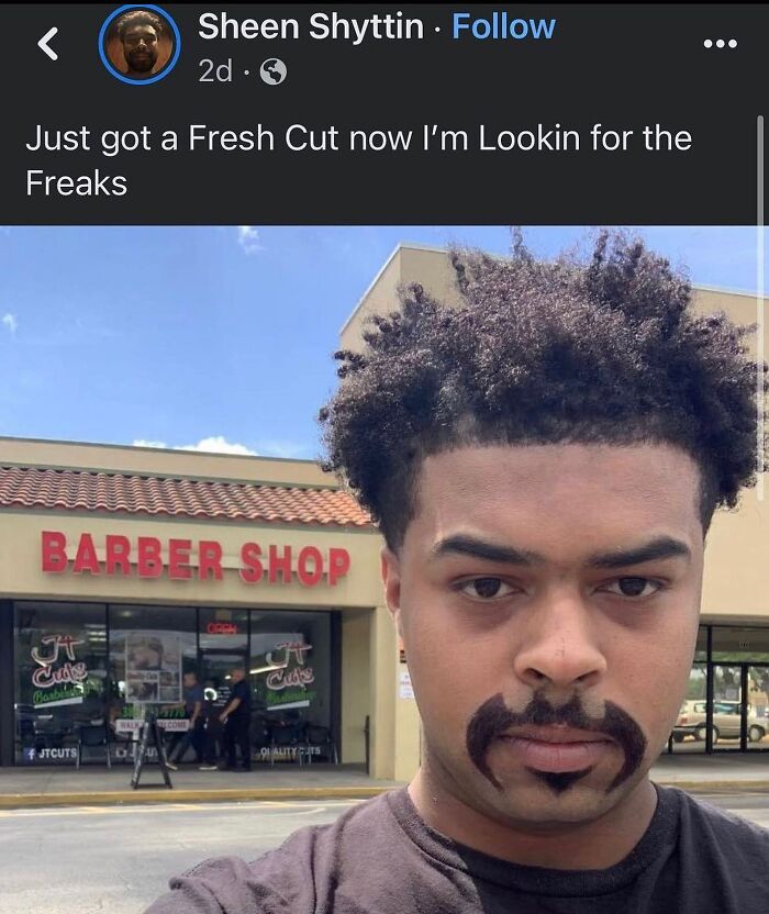A man with a unique beard design and a fresh haircut stands in front of a barber shop, perfect for weird memes.