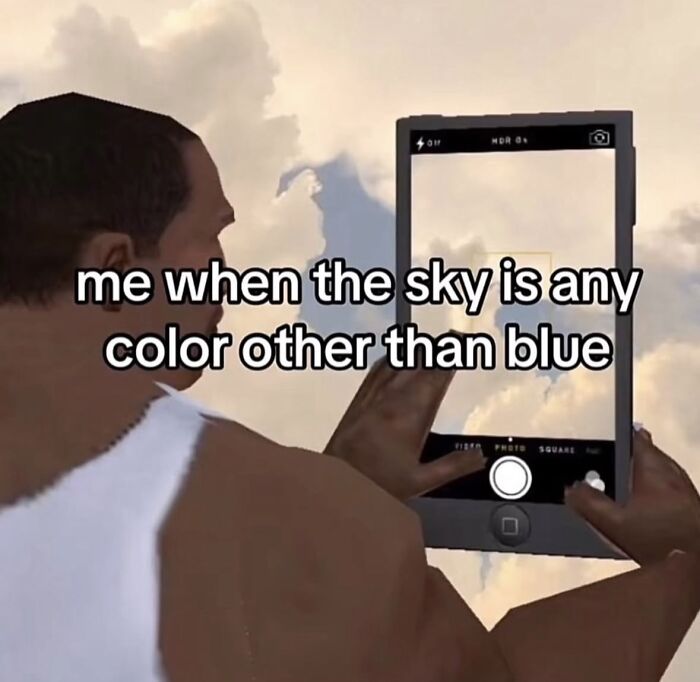 A relatable meme of a person holding a phone, ready to take a picture of a sky that is not blue, to boost morale.