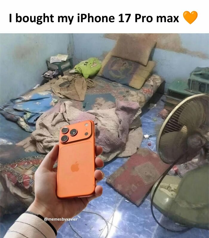 A hand holding an orange iPhone 17 Pro max in a messy room, a hilarious post from Xavier.