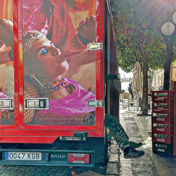Photographer captures perfectly timed coincidence in Barcelona, with a person's legs matching a model on a truck.