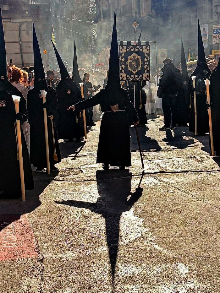 Photographer captures perfectly timed coincidences showing long shadows of robed figures in Barcelona.