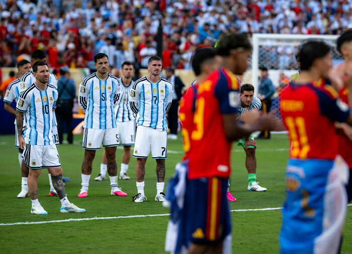 Lionel Messi and Argentina teammates on the field, reflecting on the World Cup loss and controversial behavior. Lionel Messi and Argentina teammates on the field, reflecting on the World Cup loss and controversial behavior.