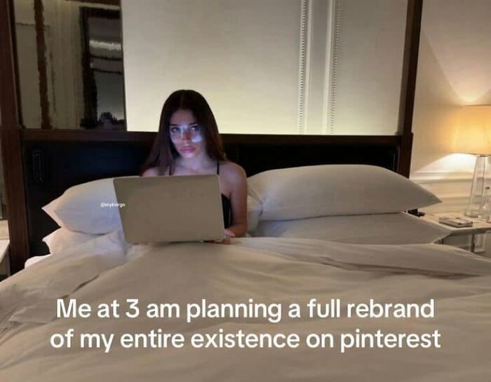 A woman working on a laptop in bed at 3 am, representing funny posts about being a woman.