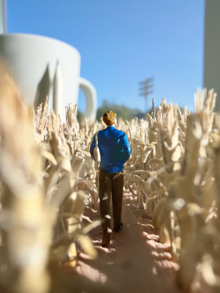 Artist Derrick Lin creates a diorama set on his office desk, showing a person walking through a field of corn.