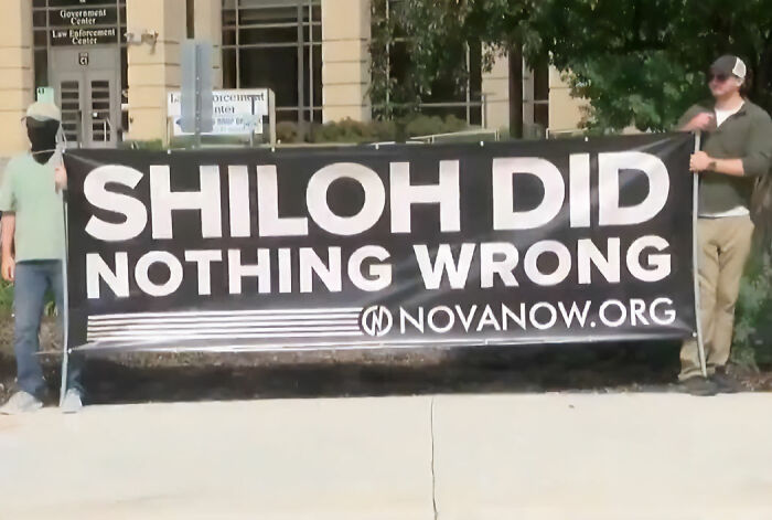 Protesters with a banner supporting the Minnesota mom after she hurled a racial slur at a Black autistic child. Protesters with a banner supporting the Minnesota mom after she hurled a racial slur at a Black autistic child.