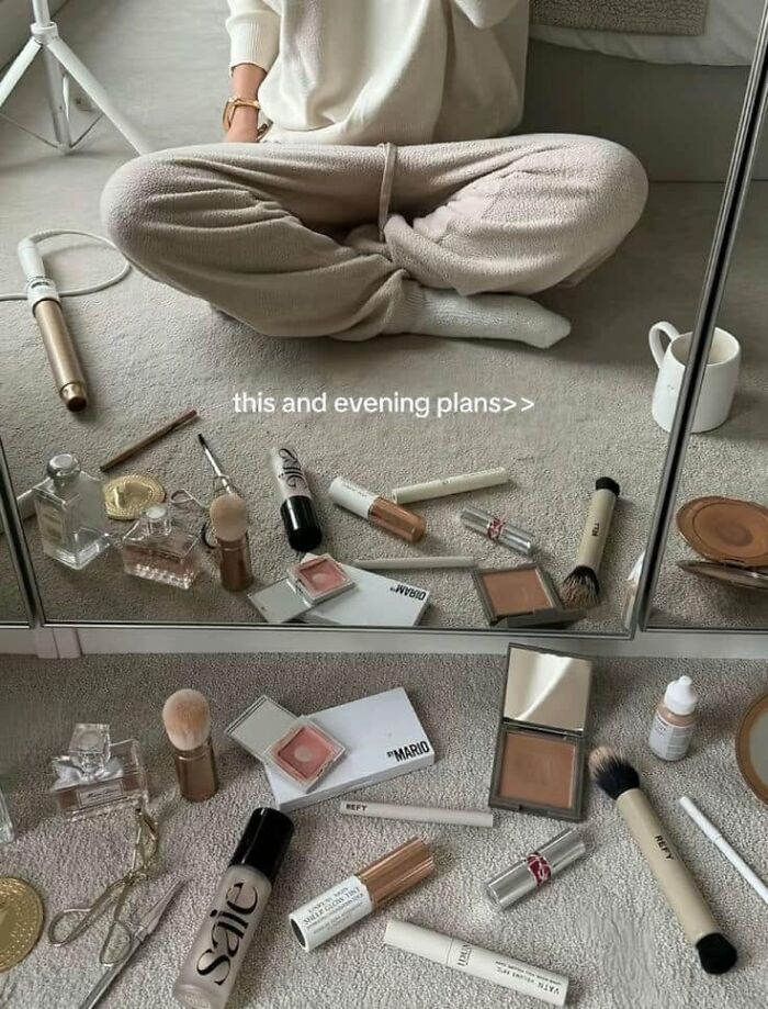 A person surrounded by makeup products on the floor, a funny post about what being a woman is like.