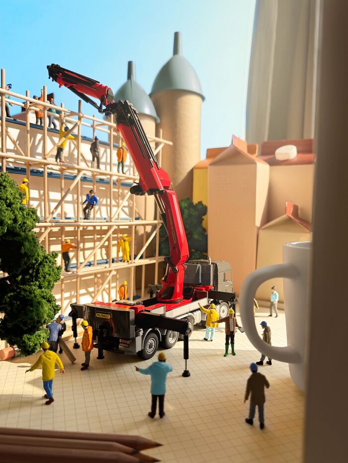 Artist Derrick Lin creates intricate diorama sets of construction workers and a crane building a structure.