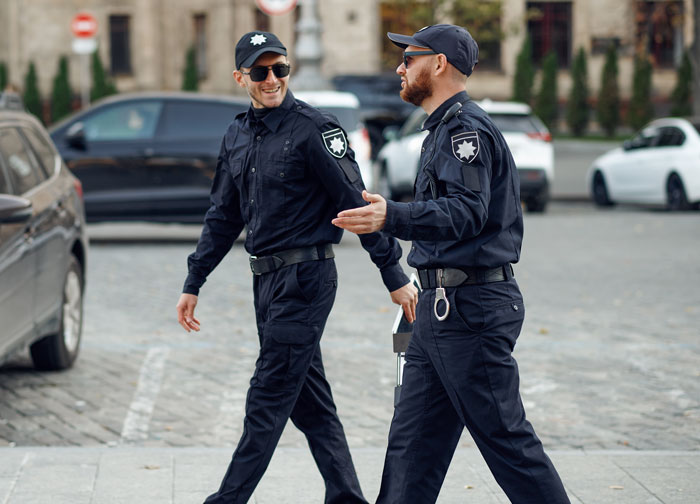 Two male cops in uniform, walking and talking, important to the Narcissist Mom and Daughter story revealing the truth. Two male cops in uniform, walking and talking, important to the Narcissist Mom and Daughter story revealing the truth.