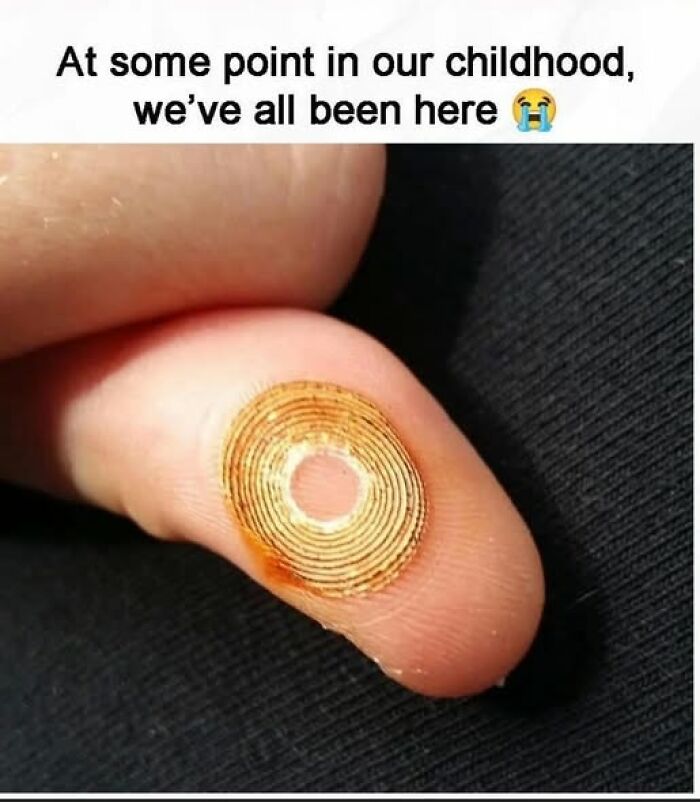 A finger with a spiral sticker stuck on it, reminding Gen X of childhood memories.