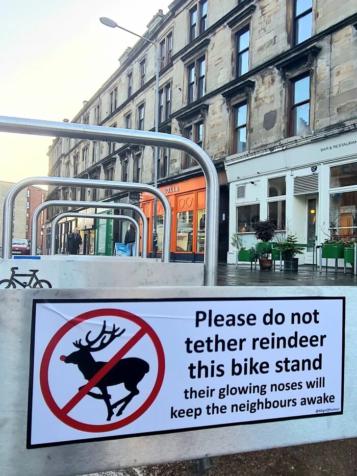 Absurd signs: A funny sign prohibiting reindeer from being tethered to a bike stand.