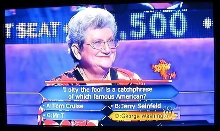 An older woman smiles, about to give a dumb Who Wants To Be A Millionaire answer, choosing George Washington.