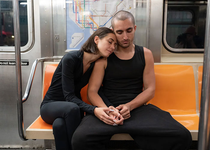 The Empire State Building daredevils, holding hands on a subway, following their arrest.