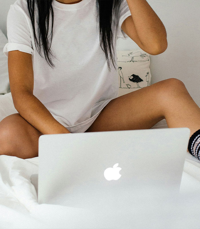 A person using a laptop, representing the adult content platform used by the professor to fund studies. A person using a laptop, representing the adult content platform used by the professor to fund studies.