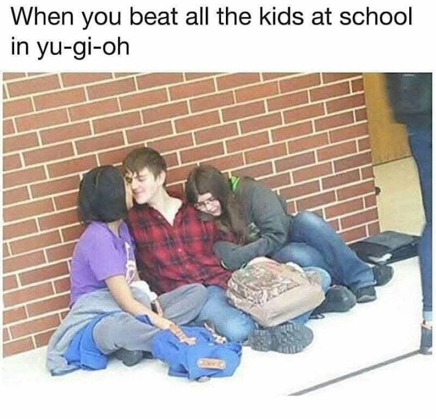 A meme showing three teenagers sitting against a brick wall, with the text When you beat all the kids at school in Yu-Gi-Oh, a '90s babies memory.