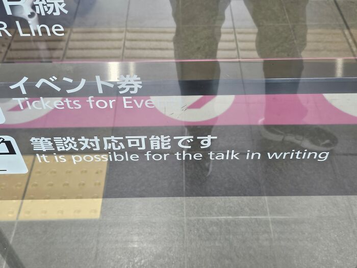 A sign at a train station in Japan showing 'It is possible for the talk in writing,' a funny lost in translation example.