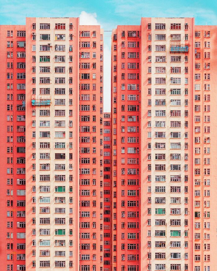 A photographer captures a perfectly composed image of two tall, narrow apartment buildings with countless windows.