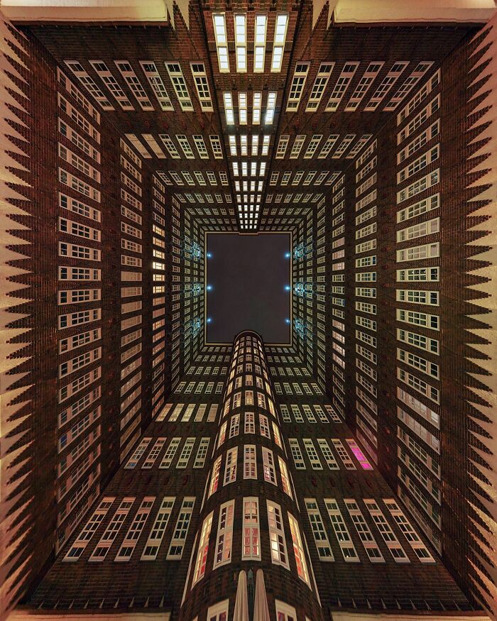 A photographer captures a perfectly composed image of a towering architectural location, looking up from its center.